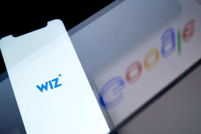 The Wiz logo on a smartphone arranged in