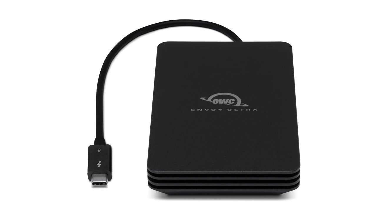 A sleek black external hard drive with engraved logo, connected by a short USB-C cable.