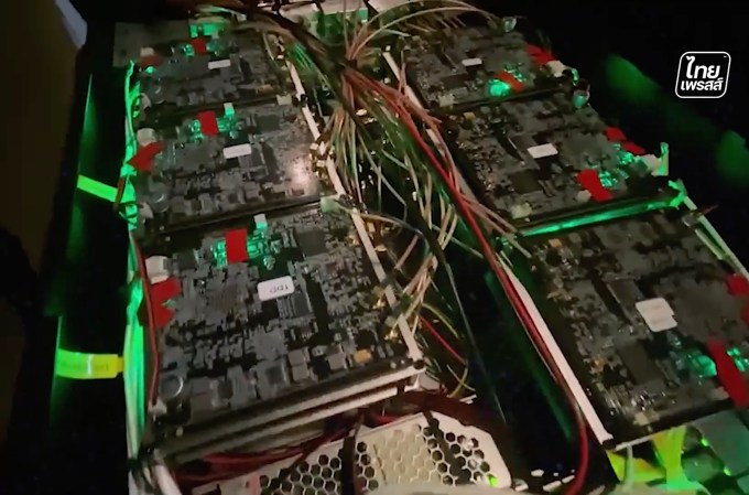 a close-up shot of SMS blaster tech in the back of a vehicle, the photo is very dark, but the router lights are flashing green.