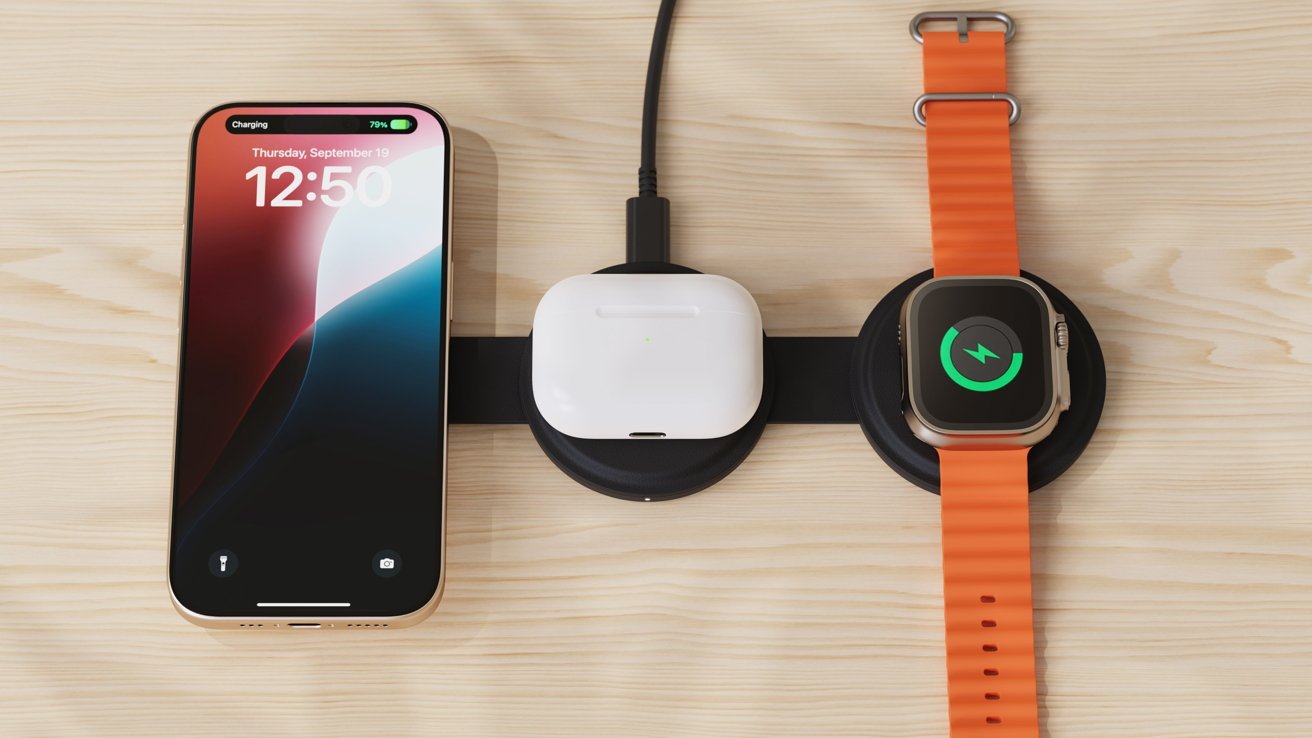 Smartphone, wireless earbuds, and smartwatch with an orange strap are charging on a wooden surface with a black charging pad.