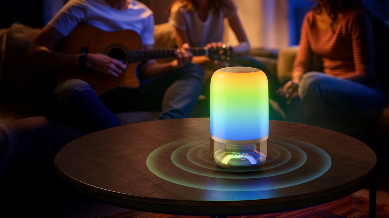 A cylindrical table lamp that is very colorful playing music