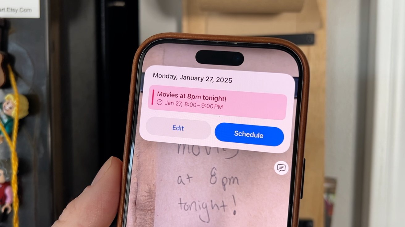 Person holding a phone displaying a reminder: 'Movies at 8pm tonight!' with options to edit or schedule. Background shows handwritten note.